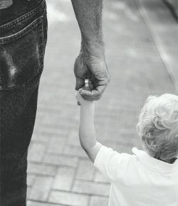 father and son holding hands
